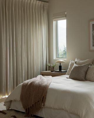 A bedroom with layered bedding