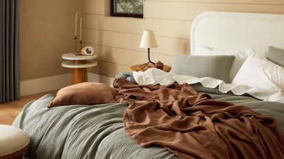 Best bed sheets - a set of the best bed sheets on a modern bed with a brown blanket