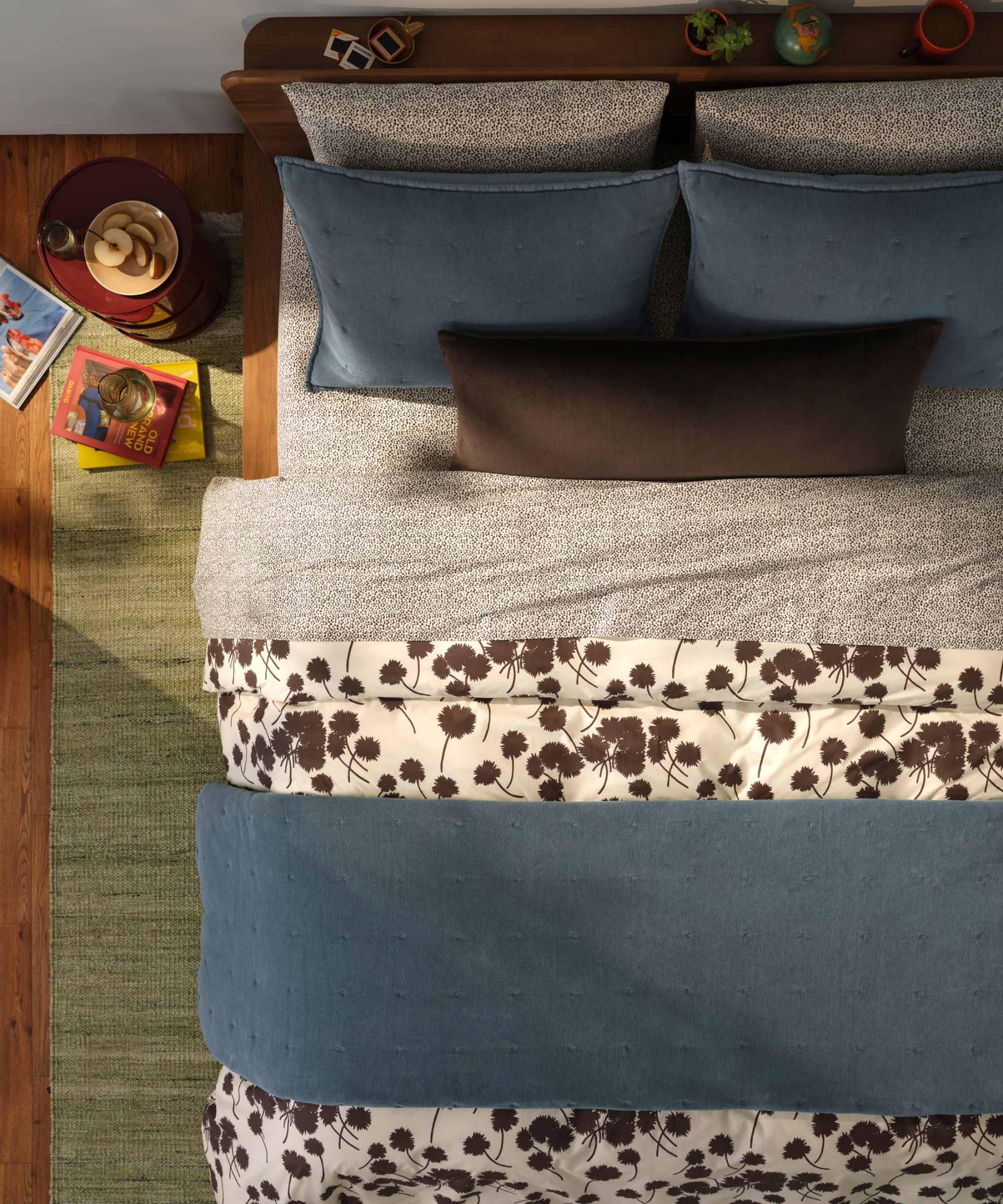 Brooklinen washed velvet quilt on a double bed with white and brown bedding seen from a birdseye view