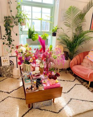 Pink colorful living room with wooden coffee table