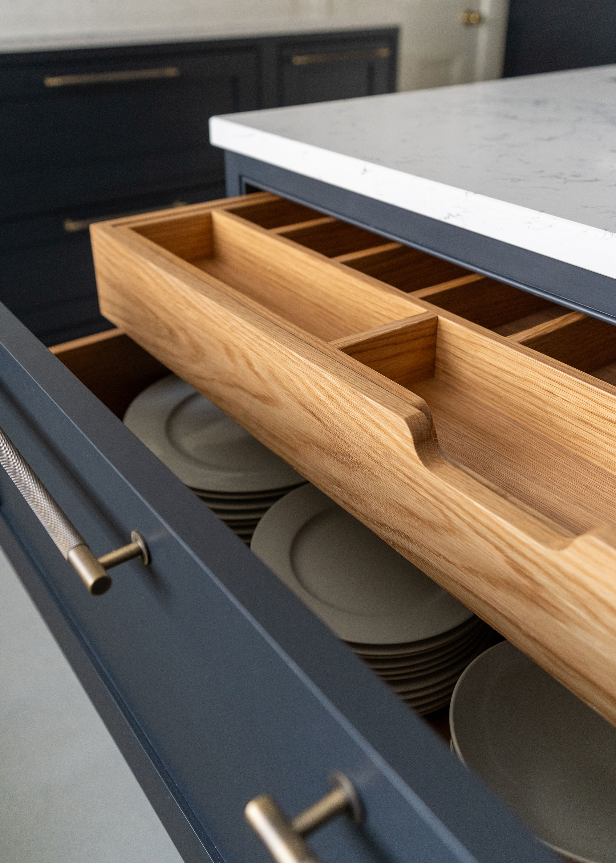 blue kitchen drawers with pull out drawer divider in a kitchen