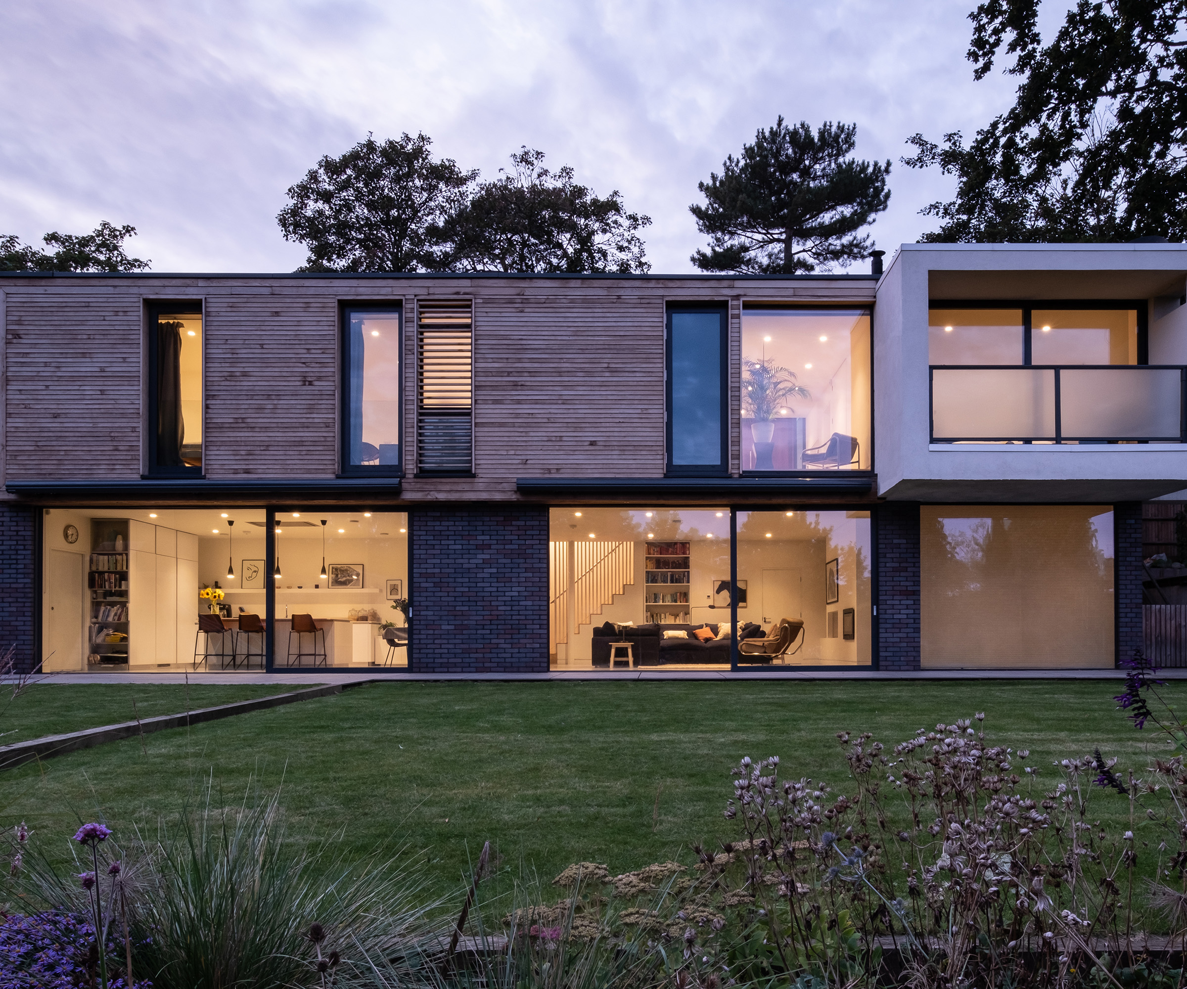 The exterior of a two storey contemporary self build home at dusk