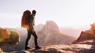 Hiker walking on mountain path, Yosemite, California