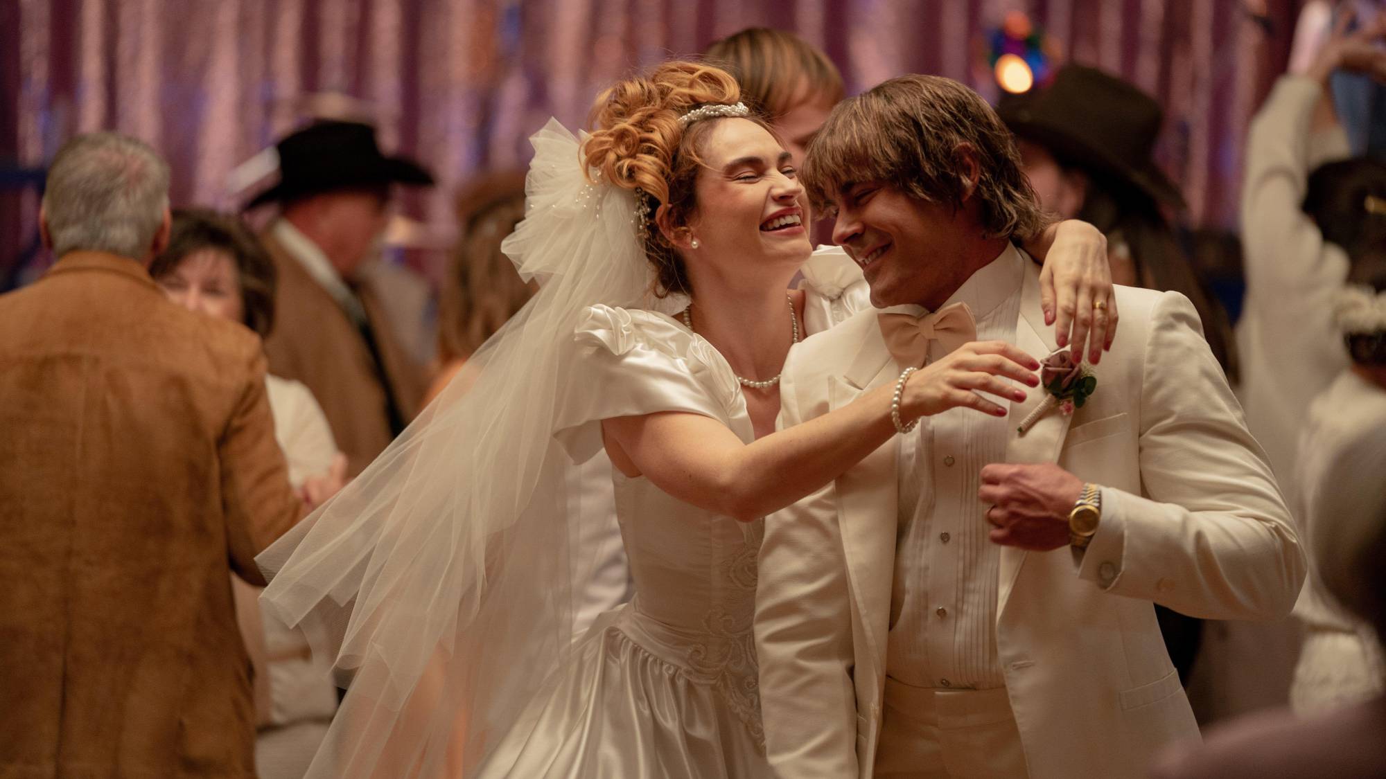 (L-R) Lily James as Pam Adkisson and Zac Efron as Kevin Von Erich in &quot;The Iron Claw&quot;