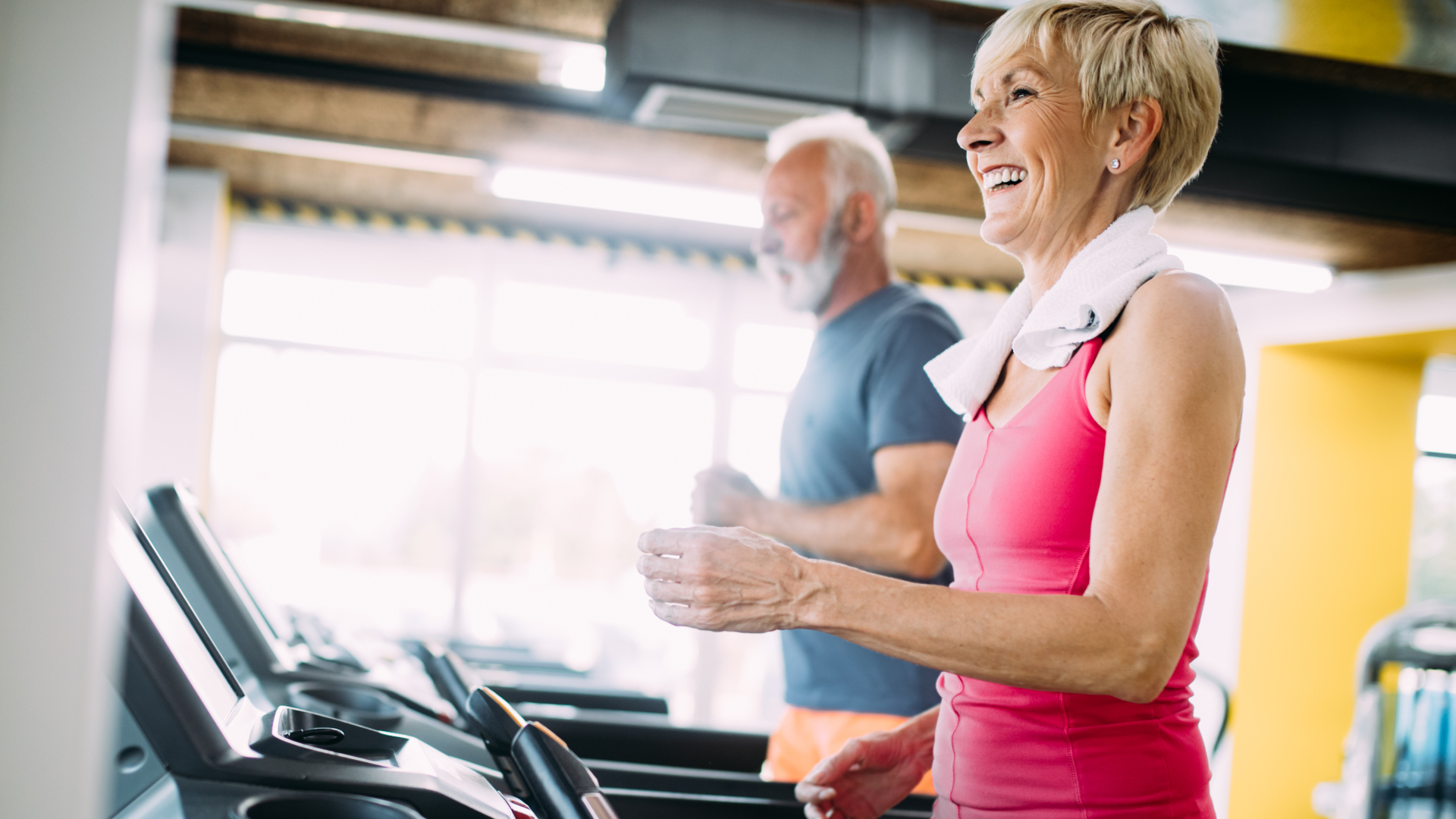 Woman and man running on treadmill