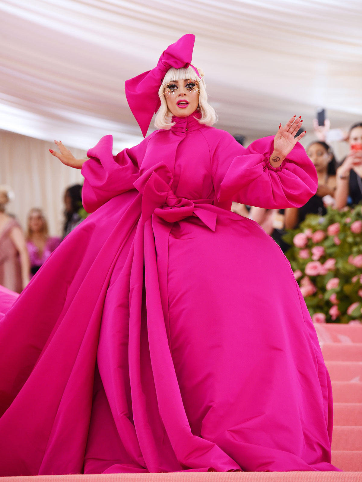 Lady Gaga wears a voluminous pink gown.