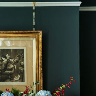 green dining room with gold framed picture