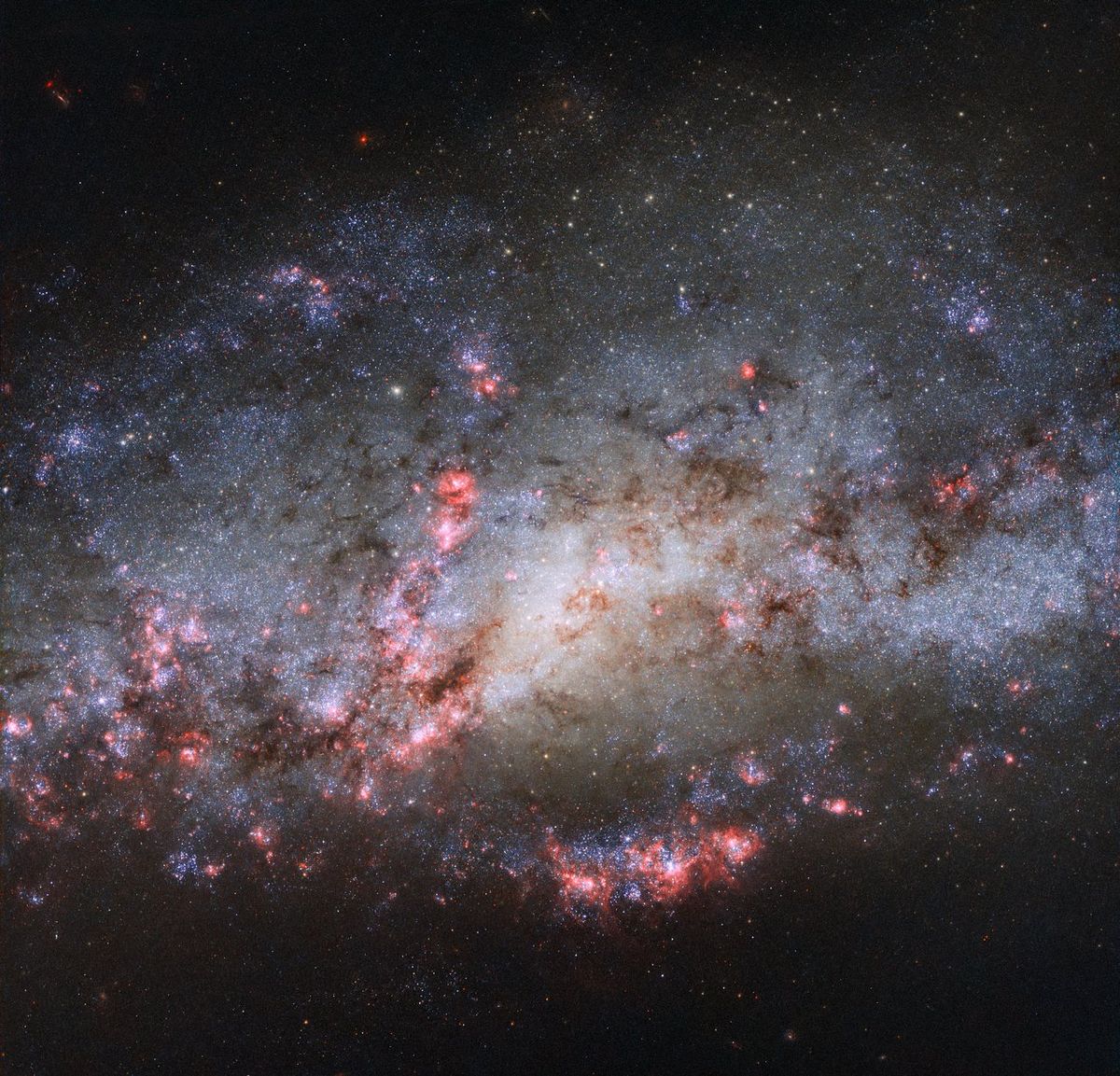 Pink Clouds Reveal Galactic Collision in New Cocoon Galaxy Image | Space