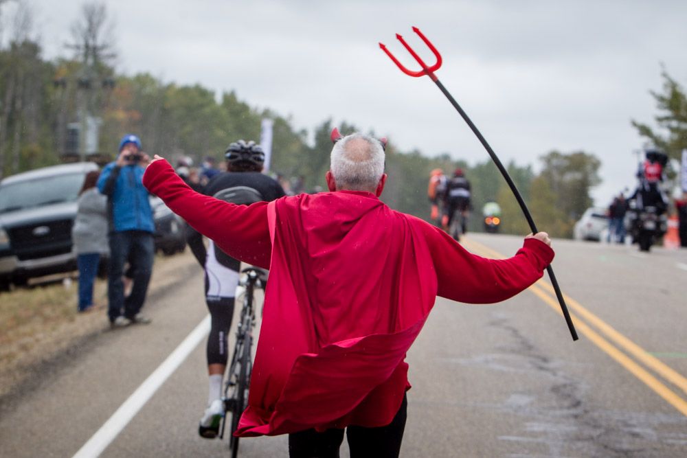 A fan cheers a rider up the KOM climb