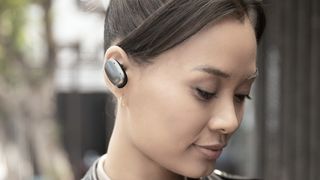 Woman wearing Shure Aonic Free wireless earbuds