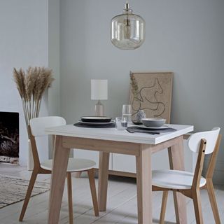 grey walled dining room with wooden flooring and and dine table