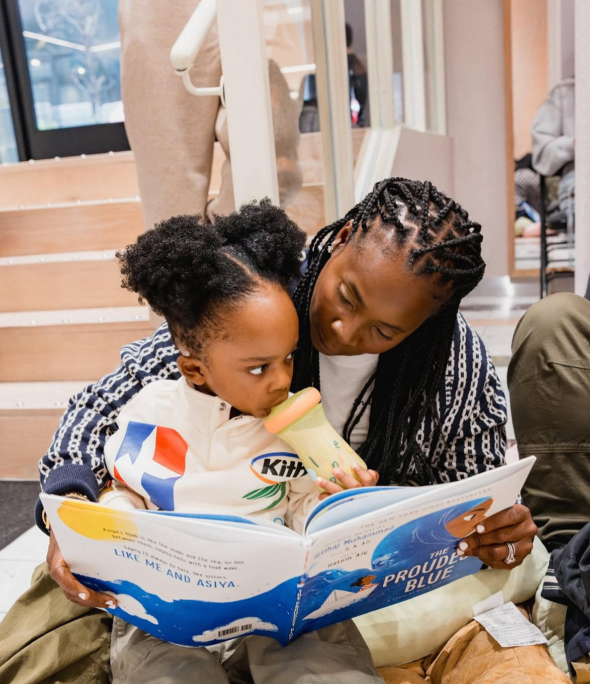 Sharifa Murdock reading a book to her son.