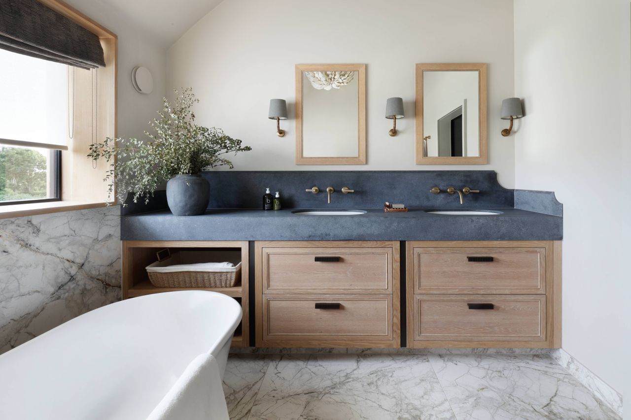 modern bathroom with dark countertop and wooden vanity unit