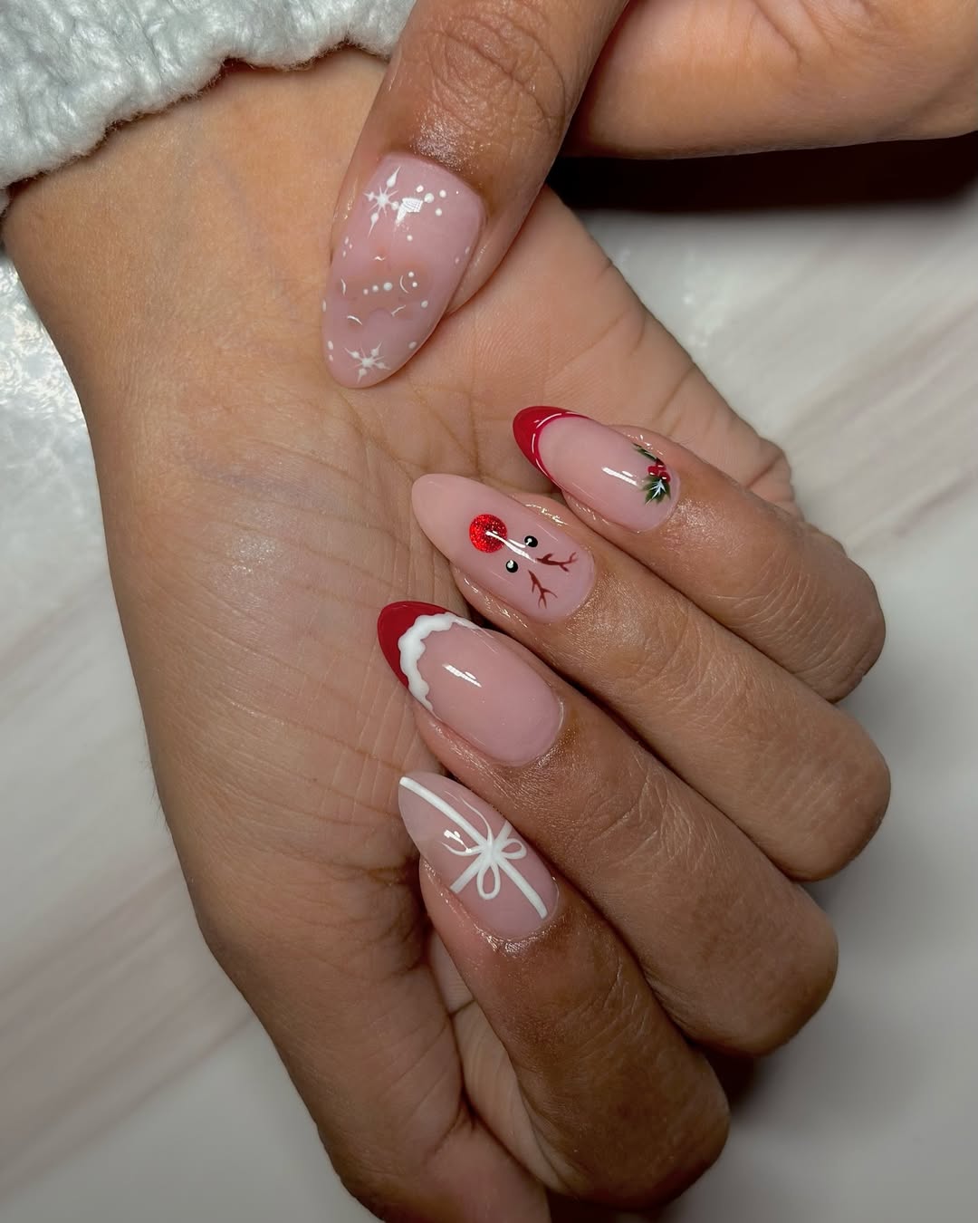 sheer pink manicure with Christmas themed nail designs