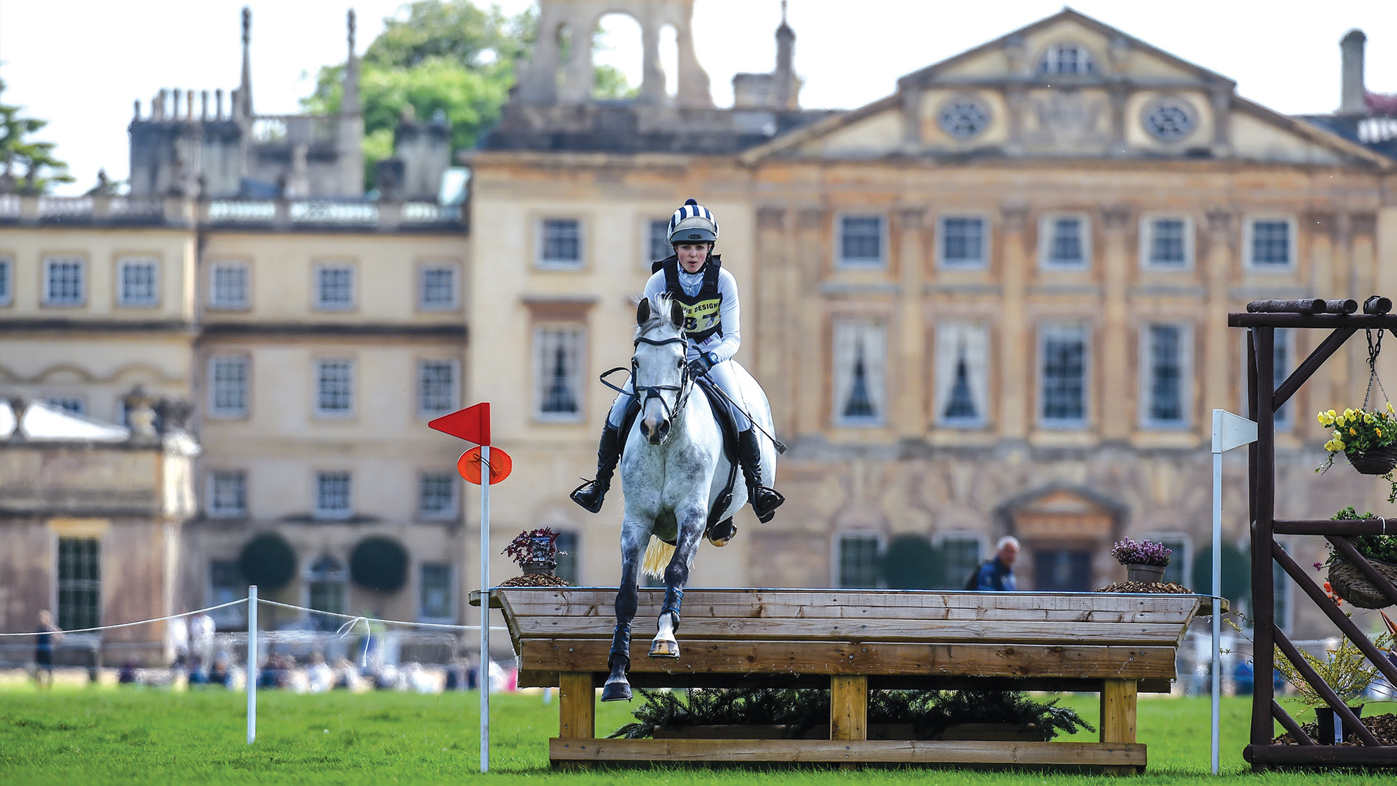 Siobhan Heneghan jumping cross-country fence in front of Badminton House at the Grassroots Championships