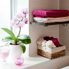 bathroom with white wall and pink bright towels