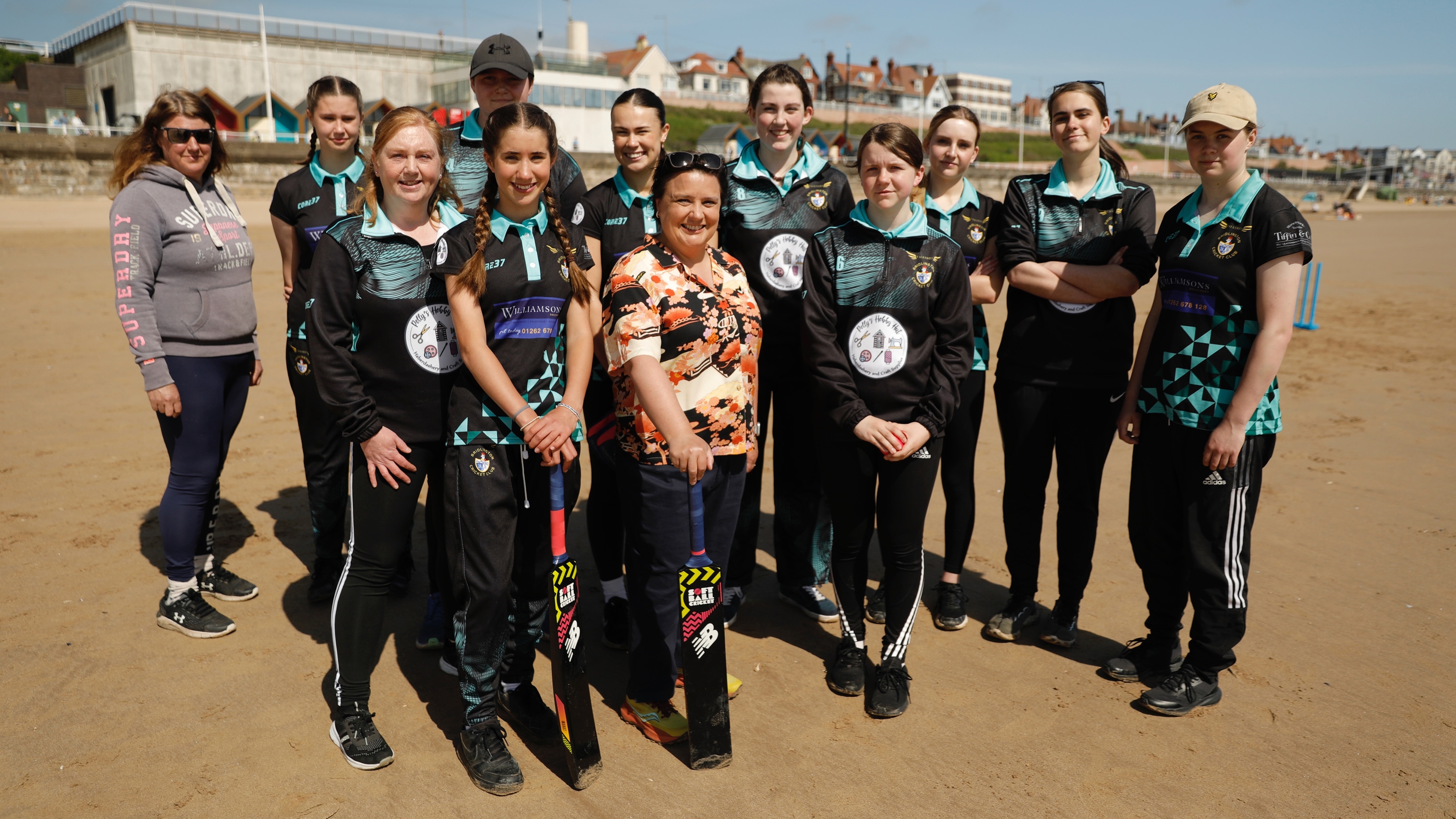 Susan on the beach with the local women's cricket team