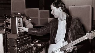 Gilmour tunes his guitar with a Peterson strobe tuner during sound check at Vredenburg in Utrecht. April 1984.