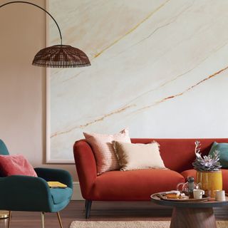 Red Sofa in front of a wallpapered living room wall