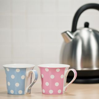 Cups with silver teapot and blur background
