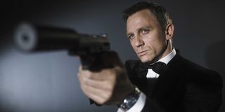 Daniel Craig with a silenced pistol as James Bond