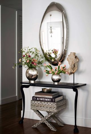 small hallway with console table and mirror