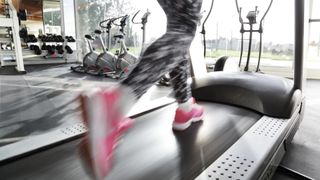 Close-up of person's feet running on treadmill