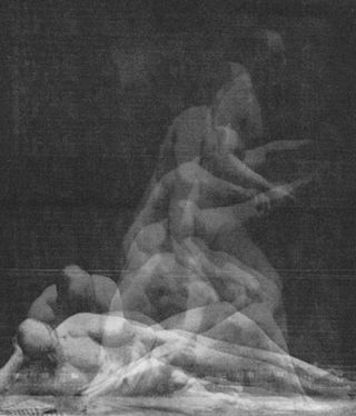 Black and white image of man laying on the floor with body rising out