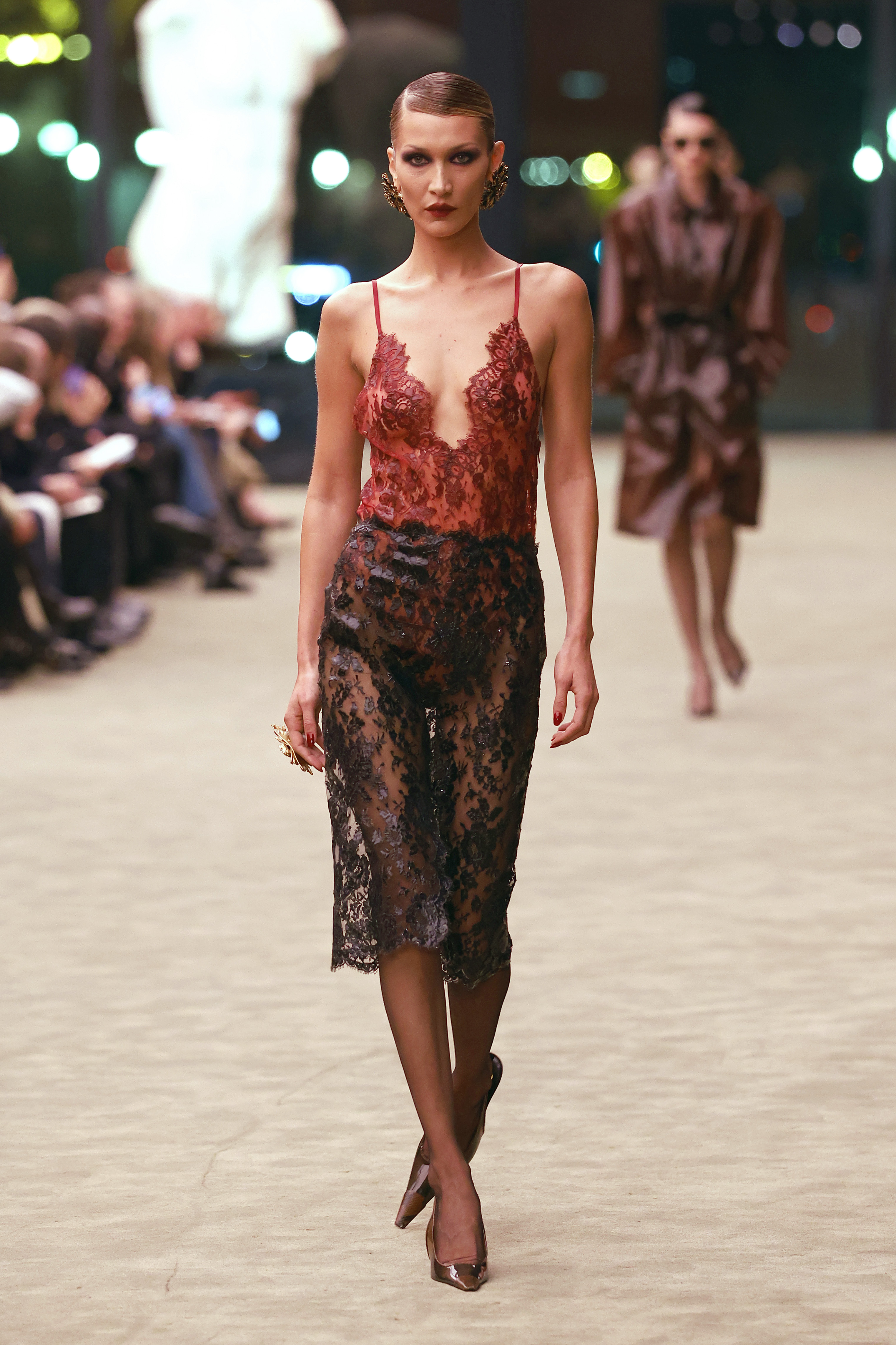 Bella Hadid returned to Saint Laurent's runway in a lingerie-inspired, Fall 2026 lace skirt set