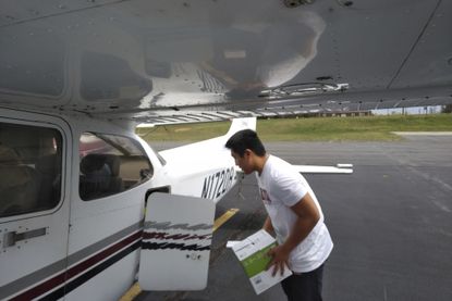 TJ Kim loads a plane