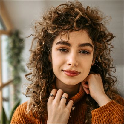 woman with short, curly hair smiling