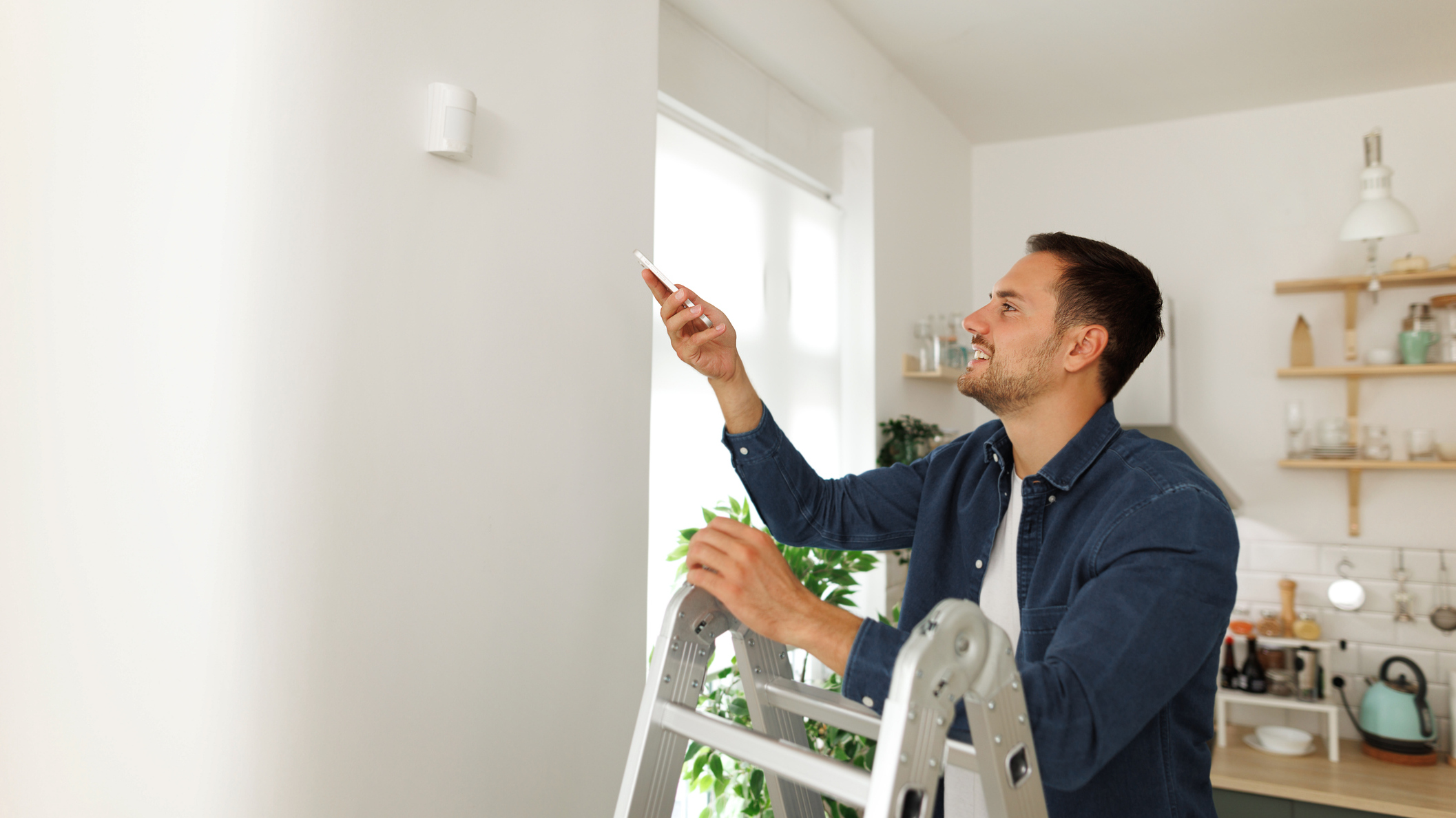 A picture of a man installing smart home items