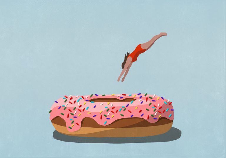 Stop emotional eating: woman diving into doughnut