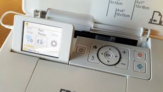 Epson PictureMate PM-400 Wireless Photo Printer being tested in writer's home