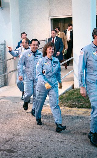 "Teacher in Space" Christa McAuliffe is seen with her crewmates exiting their quarters for the ride out to the space shuttle Challenger on the launch pad, Jan. 28, 1986.