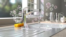 Soap bubble floating around a clean stainless steel sink