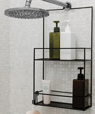 A clean, spa-like shower with hanging caddy and neutral bottles
