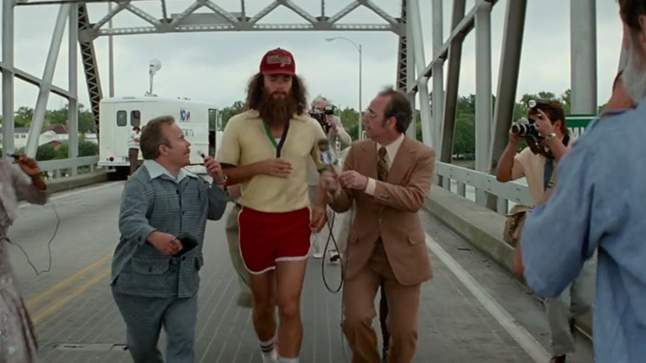 Tom Hanks in full running gear and a very long beard in Forrest Gump