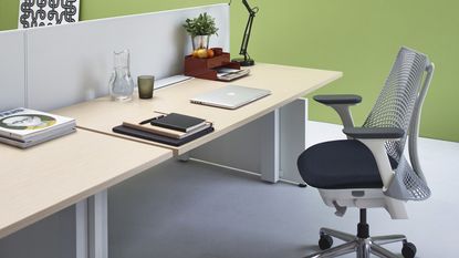 Herman Miller Sayl office chair shown positioned in front of an office desk