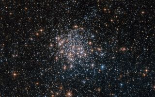 This NASA/ESA Hubble Space Telescope image shows the star cluster NGC 1854, a gathering of red, white and blue stars in the southern constellation of Dorado (The Dolphinfish).