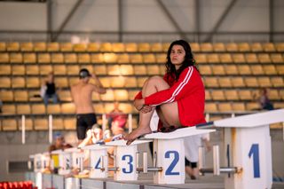 Yusra on the pool block contemplating her swimming achievement.