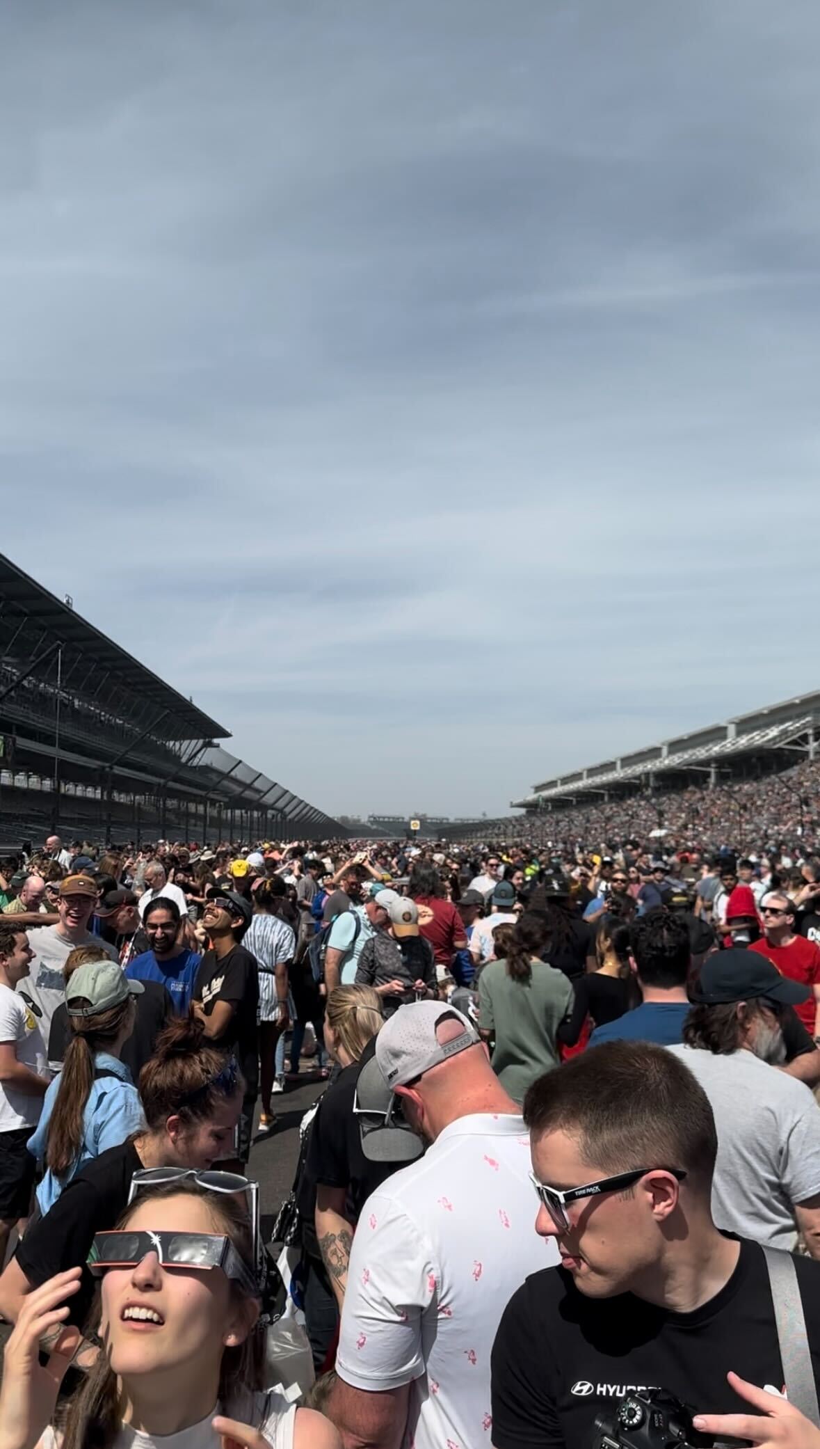A racetrack flooded with people.
