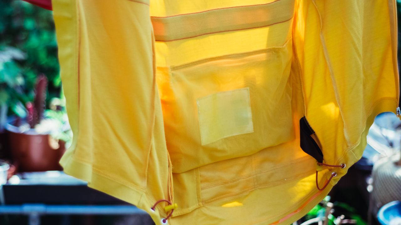 The inside mesh pocket of a yellow jersey