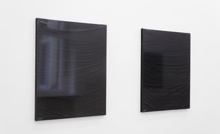 Two black canvases on the wall