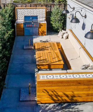 A bbq area in a narrow backyard patio