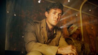 Harry Chase (Jonah Hauer-King) sitting with arms folded in World on Fire season 2