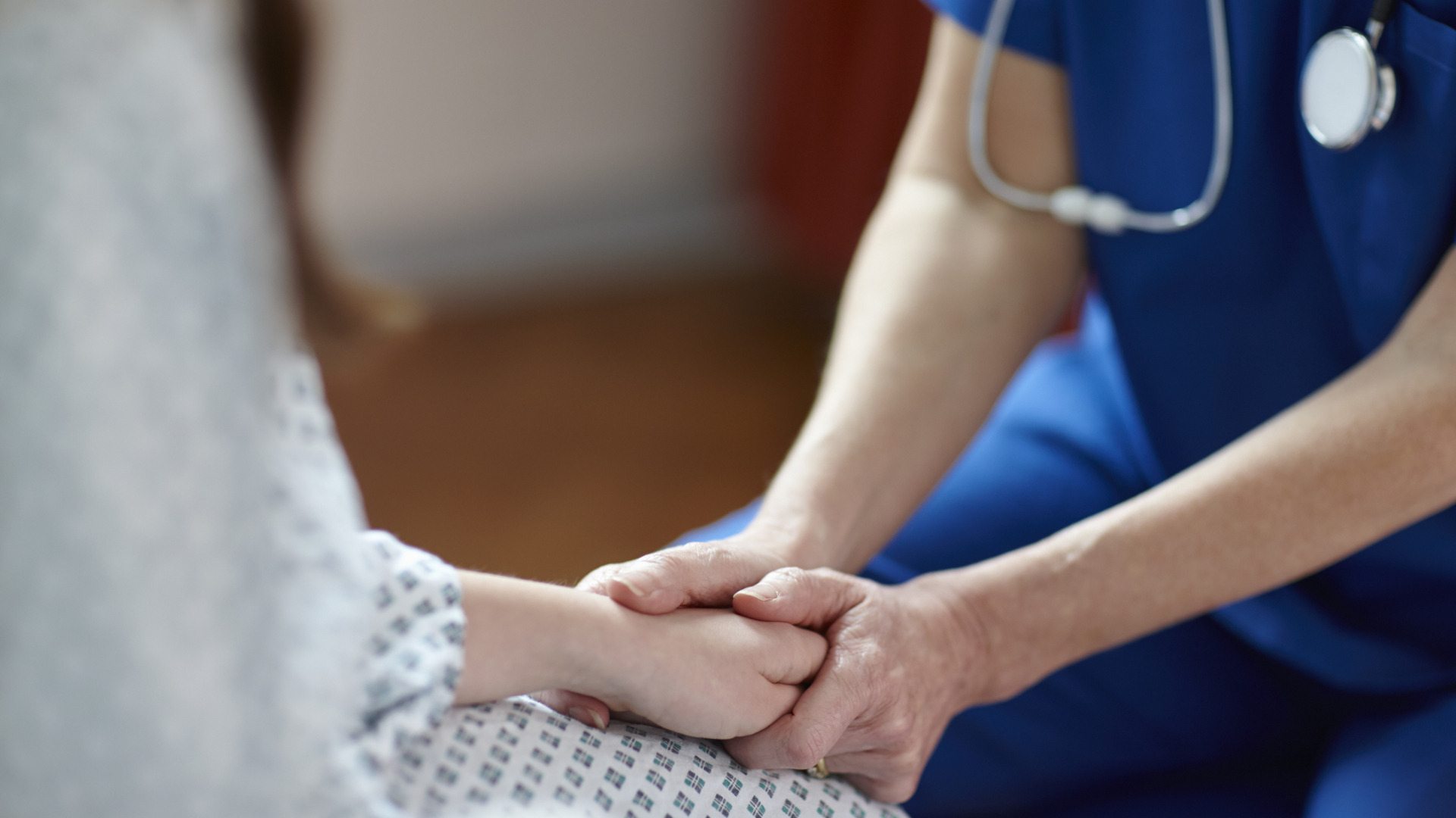 woman being comforted by a female doctor