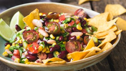 Bowl filled with Cowboy Caviar and tortilla chips