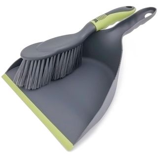 A grey and green dust pan and brush