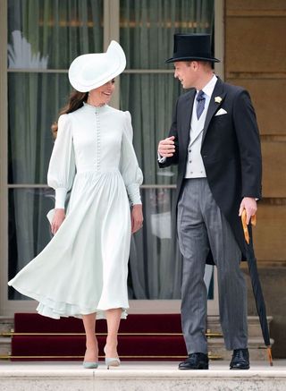 Britain's Catherine, Duchess of Cambridge (L) and her husband Britain's Prince William, Duke of Cambridge attend a Royal Garden Party at Buckingham Palace in London on May 25, 2022